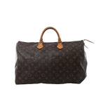Louis Vuitton Speedy 40 handbag in brown Monogram canvas with tan vachetta leather handles, zip-top closure, and leather zipper pulls on white background.