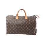 Front view of Louis Vuitton Speedy 40 Monogram canvas handbag with vachetta leather top handles and zip-top closure on a white background.