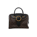 Front view of Louis Vuitton Golden Arrow Speedy 30 with brown Monogram canvas, black leather trim and handles, and a large gold-tone ring.