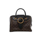 Front view of Louis Vuitton Golden Arrow Speedy 30 with brown Monogram canvas, black leather trim and handles, and a large gold-tone ring.