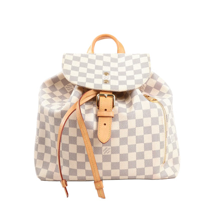 Louis Vuitton Sperone backpack in beige Damier Azur checkered canvas, featuring natural leather buckle strap, drawstring closure, top handle, and side zip pocket with gold-tone hardware.