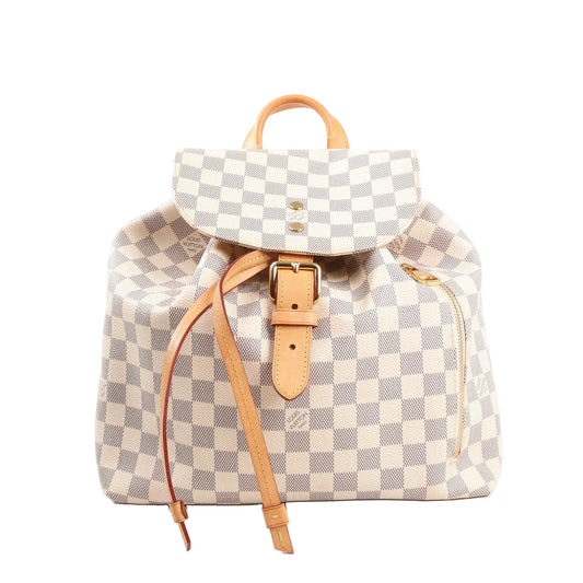 Louis Vuitton Sperone backpack in beige Damier Azur checkered canvas, featuring natural leather buckle strap, drawstring closure, top handle, and side zip pocket with gold-tone hardware.