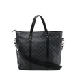 A black and grey Louis Vuitton Tadao 2Way tote bag in Damier Graphite canvas, featuring black leather top handles, side strap attachments, and silver-tone hardware.