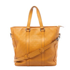 Front view of a yellow Louis Vuitton Tadao tote with embossed checkerboard leather, twin handles, a matching shoulder strap and silver-tone fittings.