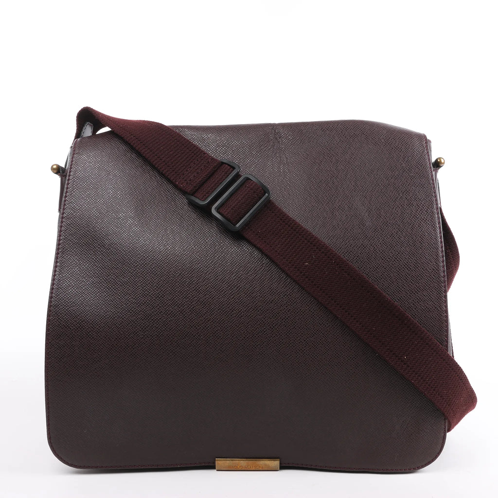 Louis Vuitton Taiga Viktor Shoulder Bag M30146 in burgundy textured leather with a matching adjustable canvas strap and gold-tone logo plate, displayed upright against a white background.