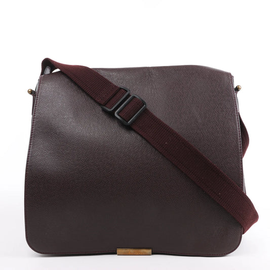 Louis Vuitton Taiga Viktor Shoulder Bag M30146 in burgundy textured leather with a matching adjustable canvas strap and gold-tone logo plate, displayed upright against a white background.