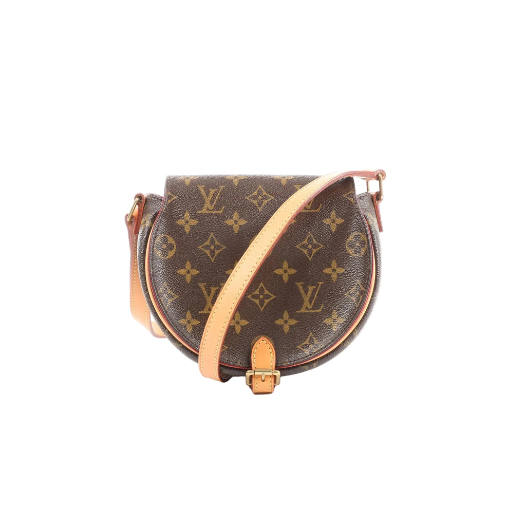 Louis Vuitton Tanblan brown Monogram canvas crossbody bag with rounded front, natural leather trim, adjustable strap, and buckle detail on a white background