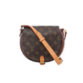 Louis Vuitton Tambourin crossbody bag in brown Monogram canvas with natural leather adjustable shoulder strap, gold-tone hardware and a rounded flap silhouette.