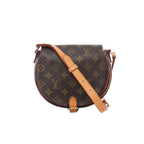 Louis Vuitton Tambourin crossbody bag in brown Monogram canvas with natural leather adjustable shoulder strap, gold-tone hardware and a rounded flap silhouette.