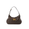 Louis Vuitton Thames GM Damier Ebene shoulder bag in brown check canvas with dark leather trim, gold-tone plaque, and zip-top closure, front view on white background.