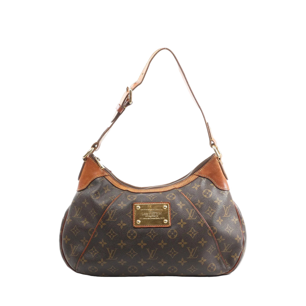 Louis Vuitton Thames GM shoulder bag in brown Monogram canvas with tan leather trim, adjustable shoulder strap, and gold-tone logo plaque, front view on white background.