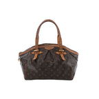 Louis Vuitton Tivoli GM handbag in brown Monogram canvas with natural leather adjustable shoulder handles, pleated front detail and zip-top closure.