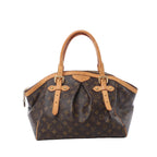 Louis Vuitton Tivoli GM handbag in brown Monogram canvas with tan vachetta leather trim, pleated front, top handles, and gold-tone hardware on white background.
