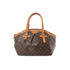 Louis Vuitton Tivoli GM handbag in brown Monogram canvas with tan leather trim, double top handles, and zip-top closure on white background
