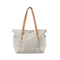 Louis Vuitton Totally MM shoulder bag in beige Damier Azur canvas with tan vachetta leather straps, gold-tone hardware, zip top and side pockets on white background.
