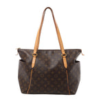 Front view of a brown Louis Vuitton Totally MM tote with Monogram canvas, tan leather shoulder straps and piping, open side pockets and gold-tone fittings.