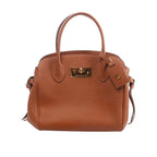 Brown Louis Vuitton Milla PM handbag in pebbled leather with dual top handles, gold-tone turn-lock hardware and hanging leather tag.