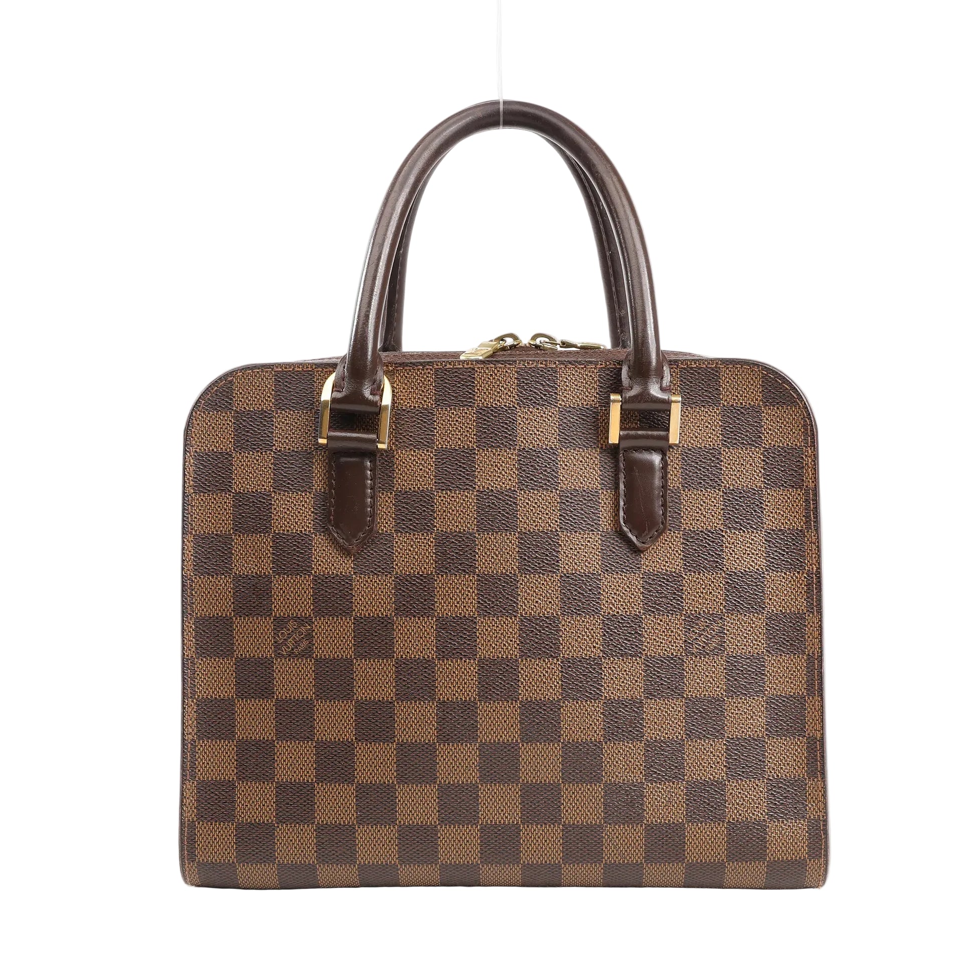 Louis Vuitton Triana handbag in brown Damier Ebene canvas with structured square silhouette, dual rolled leather handles, and gold-tone hardware, displayed on a white background.