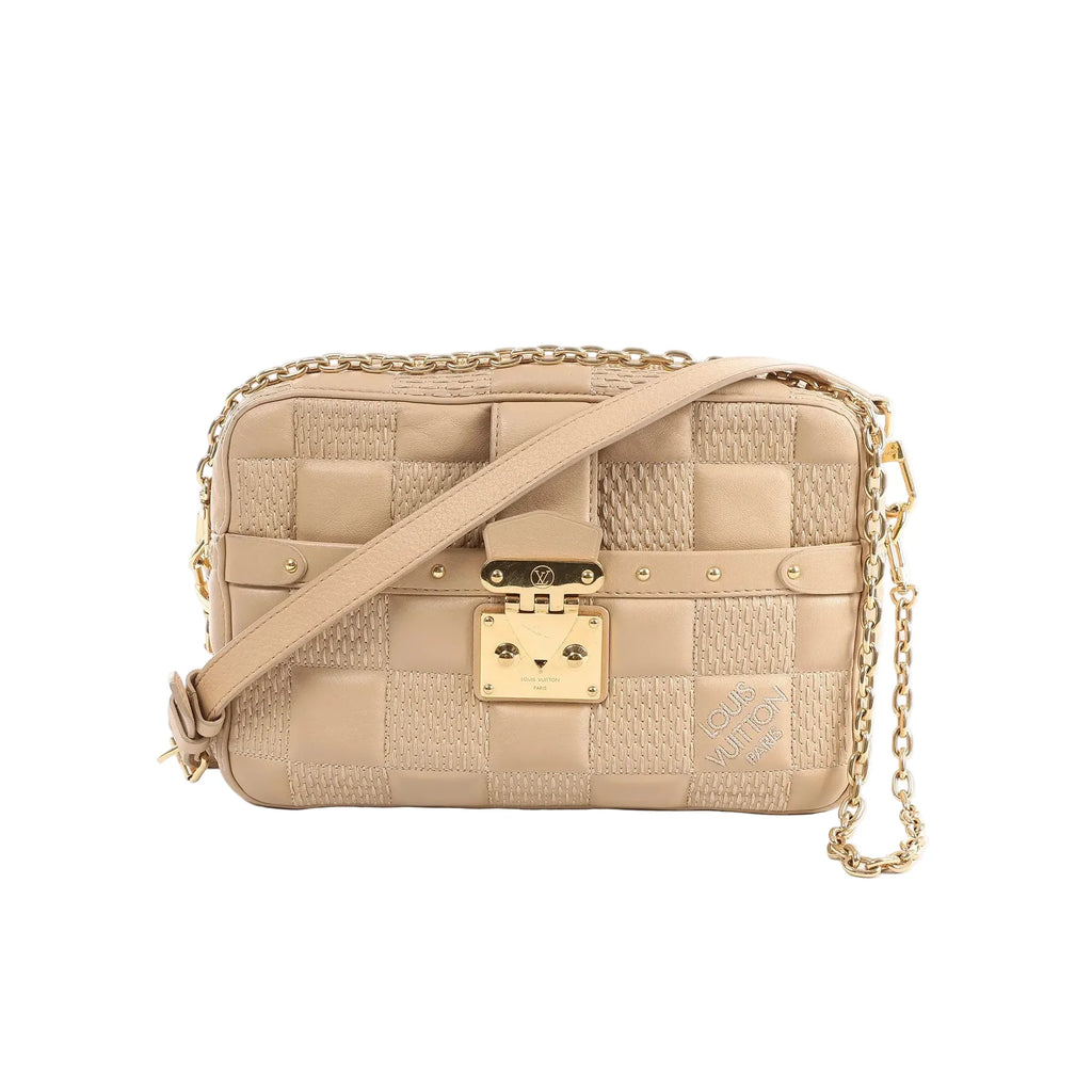 Beige Louis Vuitton Troca MM Damier quilt leather crossbody bag with gold-tone padlock clasp, chain strap detail, and adjustable shoulder strap.