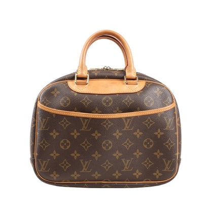 Front view of a Louis Vuitton Trouville M42228 handbag in brown Monogram Canvas with natural leather trim, dual rolled handles, and an exterior slip pocket.