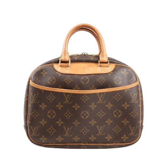 Front view of a Louis Vuitton Trouville M42228 handbag in brown Monogram Canvas with natural leather trim, dual rolled handles, and an exterior slip pocket.