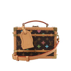 Brown Louis Vuitton trunk-style crossbody bag with multicolor Monogram canvas, tan leather trim, brass corner hardware, top handle, luggage tag, and shoulder strap on white background.