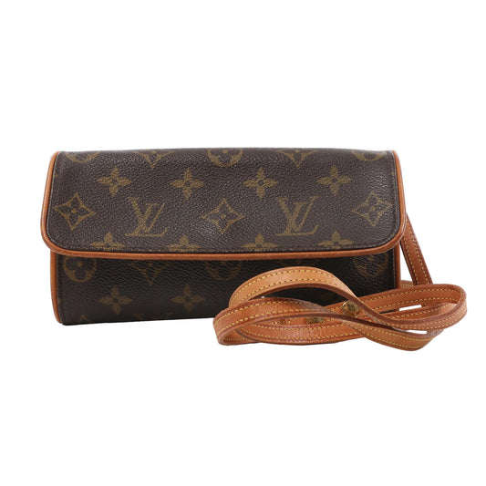 Front view of the Louis Vuitton Monogram Canvas Pochette Twin PM Shoulder Bag M51854, featuring signature brown monogram canvas, natural leather trim and strap, flap closure, and a slim rectangular shape, displayed against a white background.