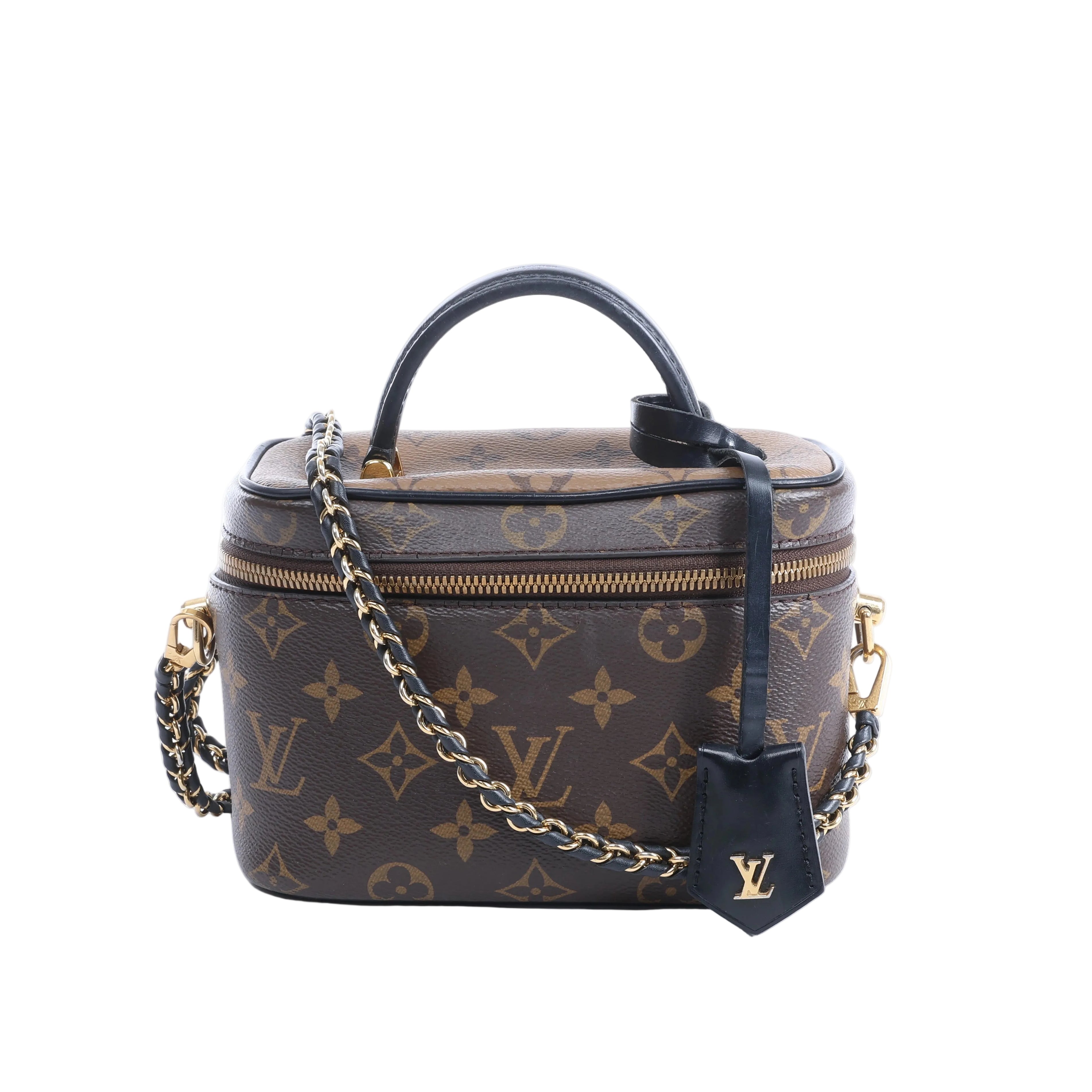 Brown Louis Vuitton Vanity NV PM Monogram bag with black leather top handle, gold-tone chain strap and zip closure.