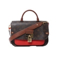 Front view of Louis Vuitton Vaugirard PM bag in brown Monogram canvas with red leather base, top handle, adjustable shoulder strap, and gold-tone padlock clasp.