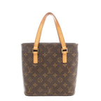 Louis Vuitton Vavin PM shoulder bag in brown Monogram coated canvas with natural cowhide leather shoulder straps, structured tote silhouette, and gold-tone hardware on a white background.