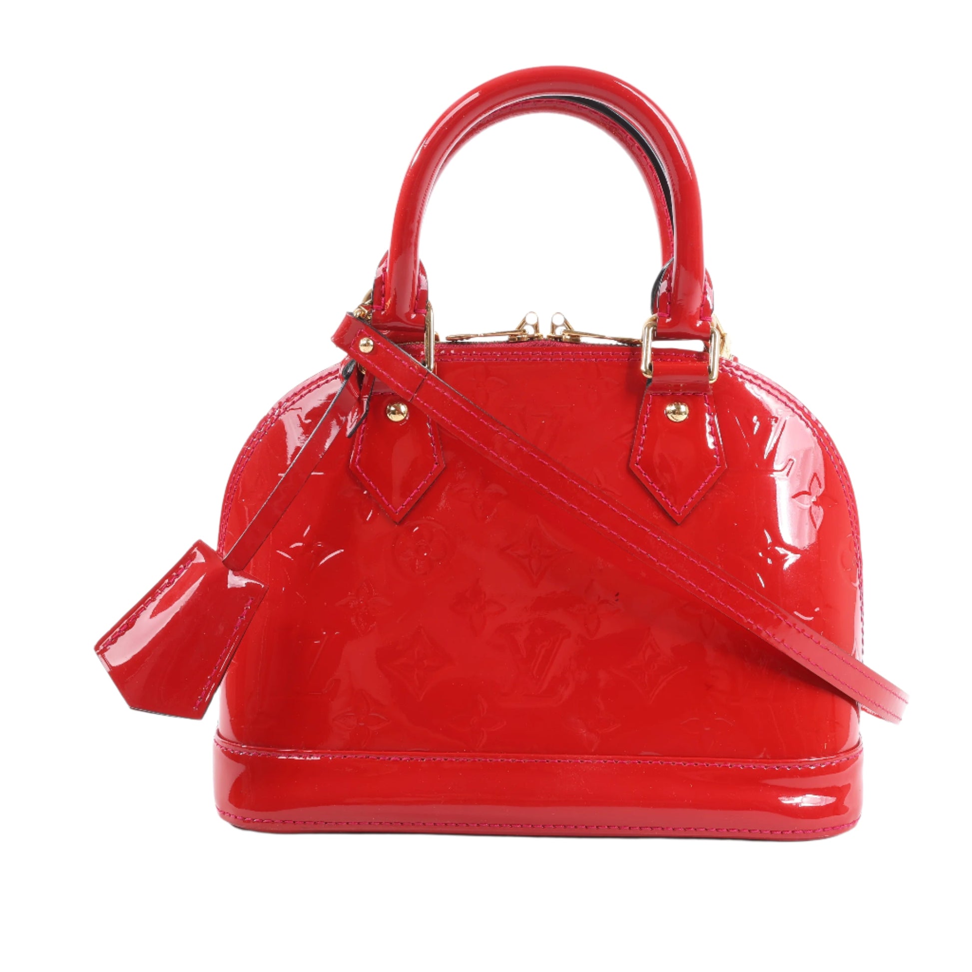 Red patent leather handbag with gold accents on a white background
