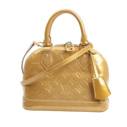 Louis Vuitton Alma BB Handbag M91752 in glossy gold Monogram Vernis patent leather with dual top handles, detachable crossbody strap, and gold-tone hardware.