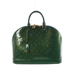 Green Louis Vuitton Alma GM handbag in embossed Monogram Vernis patent leather with two top handles and gold-tone hardware.