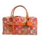 Louis Vuitton Weekender PM bag in Monogram Pulp canvas with vivid orange, red, and yellow graffiti-style print, featuring orange leather trim, dual top handles, luggage tag, and gold-tone hardware.