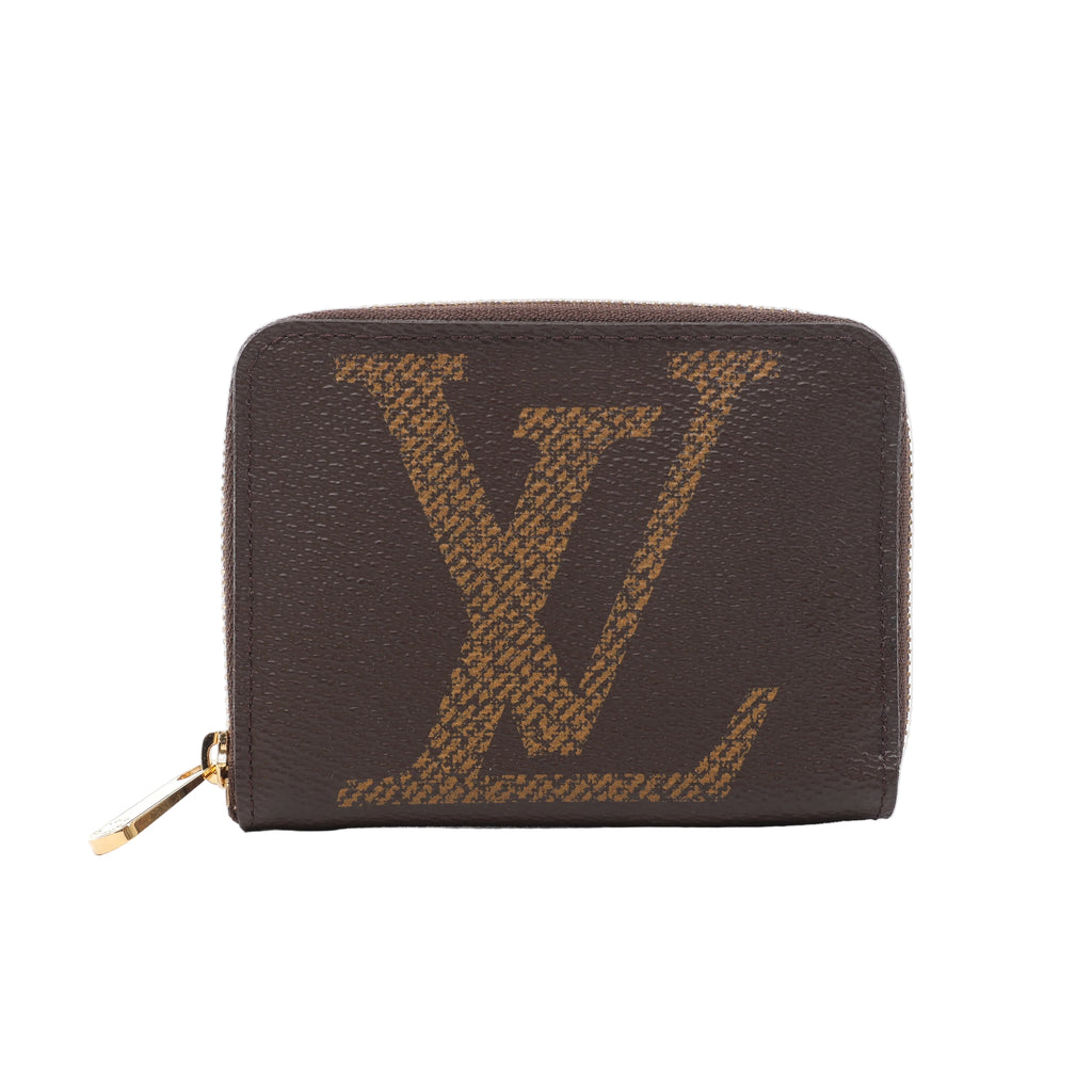 Brown Louis Vuitton Zippy wallet with an oversized tan LV motif, rounded corners and a gold-tone zip-around closure.