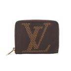 Brown Louis Vuitton Zippy wallet with an oversized tan LV motif, rounded corners and a gold-tone zip-around closure.