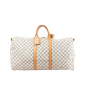 Louis Vuitton Damier Azur Keepall 55 travel bag with tan leather handles, vertical leather straps, luggage tag, and top zip on white background (shoulder strap not shown)