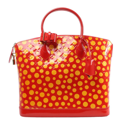 Louis Vuitton x Yayoi Kusama Lockit MM handbag in glossy red Vernis leather, covered with bold yellow polka dots, featuring top handles, gold-tone lock hardware, and a structured silhouette, displayed against a white background.