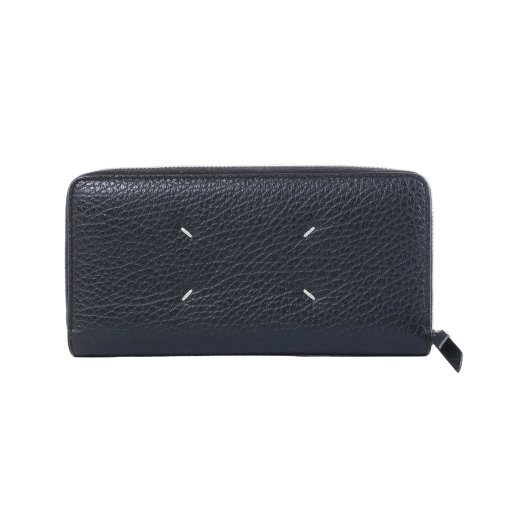 Maison Margiela black textured leather zip-around wallet with four white signature stitches and black zipper pull.