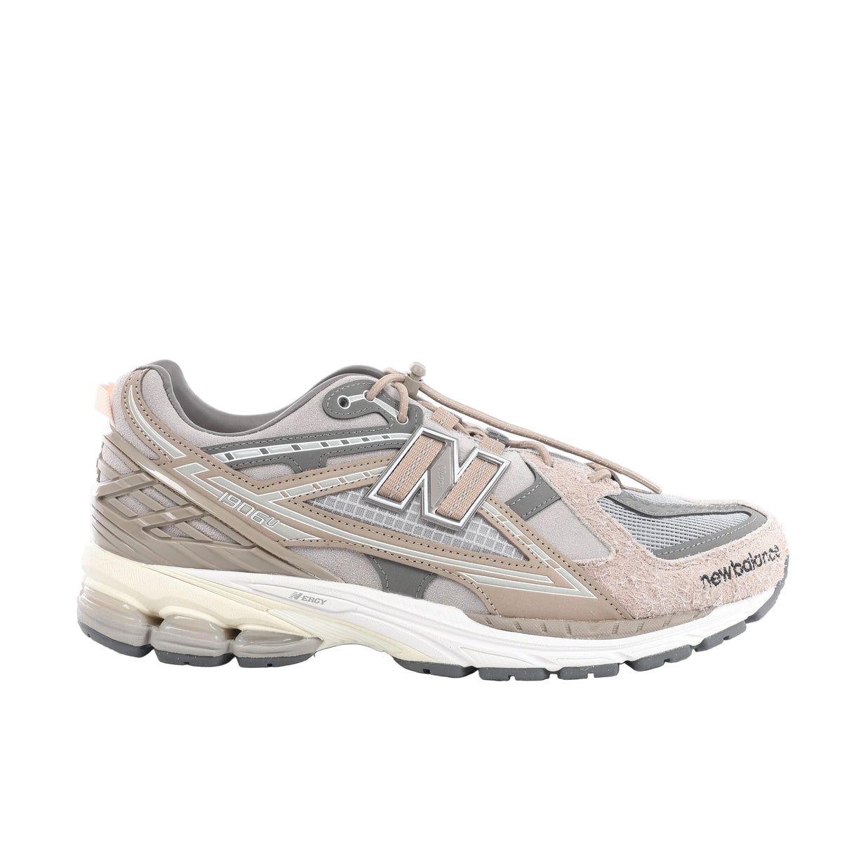 Side view of a grey and taupe New Balance sneaker with mesh panels, textured overlays, a large N logo, toggle laces and a cream midsole.