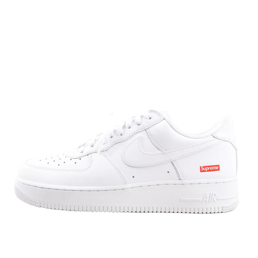 Nike x Supreme Air Force 1 Low SP sneaker in white leather, side view showing perforated toe box, Swoosh logo, and red Supreme box logo on the heel, EU size 43.