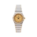 Omega Constellation watch with champagne dial, diamond-accent bezel, two-tone stainless steel and yellow gold bracelet, and gold-tone hands.