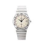 Omega Constellation stainless steel watch with champagne-beige dial, Roman numeral bezel, date window at 3 o’clock, baton hour markers, and stainless steel bracelet.