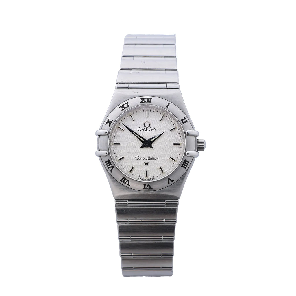 Omega Constellation stainless steel watch with beige dial, Roman numeral bezel, black hands, baton hour markers, and integrated bracelet strap on white background.