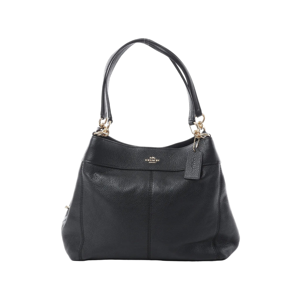 Coach Lexy black pebbled leather shoulder bag with gold-tone hardware, double shoulder straps, Coach logo, and hanging leather tag on white background