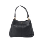 Coach Lexy black pebbled leather shoulder bag with gold-tone hardware, double shoulder straps, Coach logo, and hanging leather tag on white background