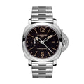 Panerai Luminor GMT watch with stainless steel bracelet, black dial with gold-tone hour markers, 24-hour scale, date window at 3 o’clock, small seconds subdial, and crown-guard lever.