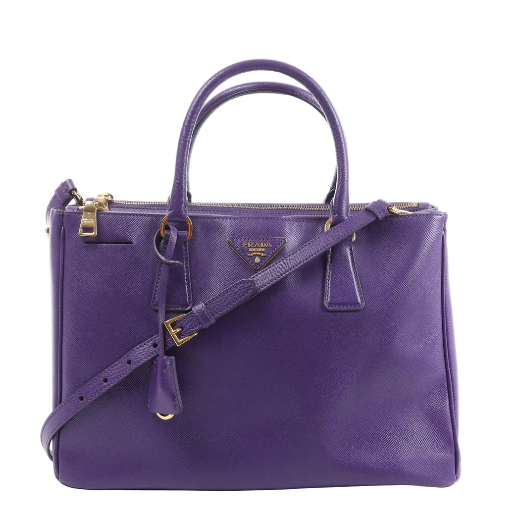 Prada Galleria handbag in purple Saffiano leather with rolled top handles, detachable shoulder strap, gold-tone hardware and triangle logo.