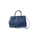 Prada Galleria Saffiano Lux handbag in blue Saffiano leather with dual top handles, detachable shoulder strap, gold-tone logo plaque and zip-top closure.