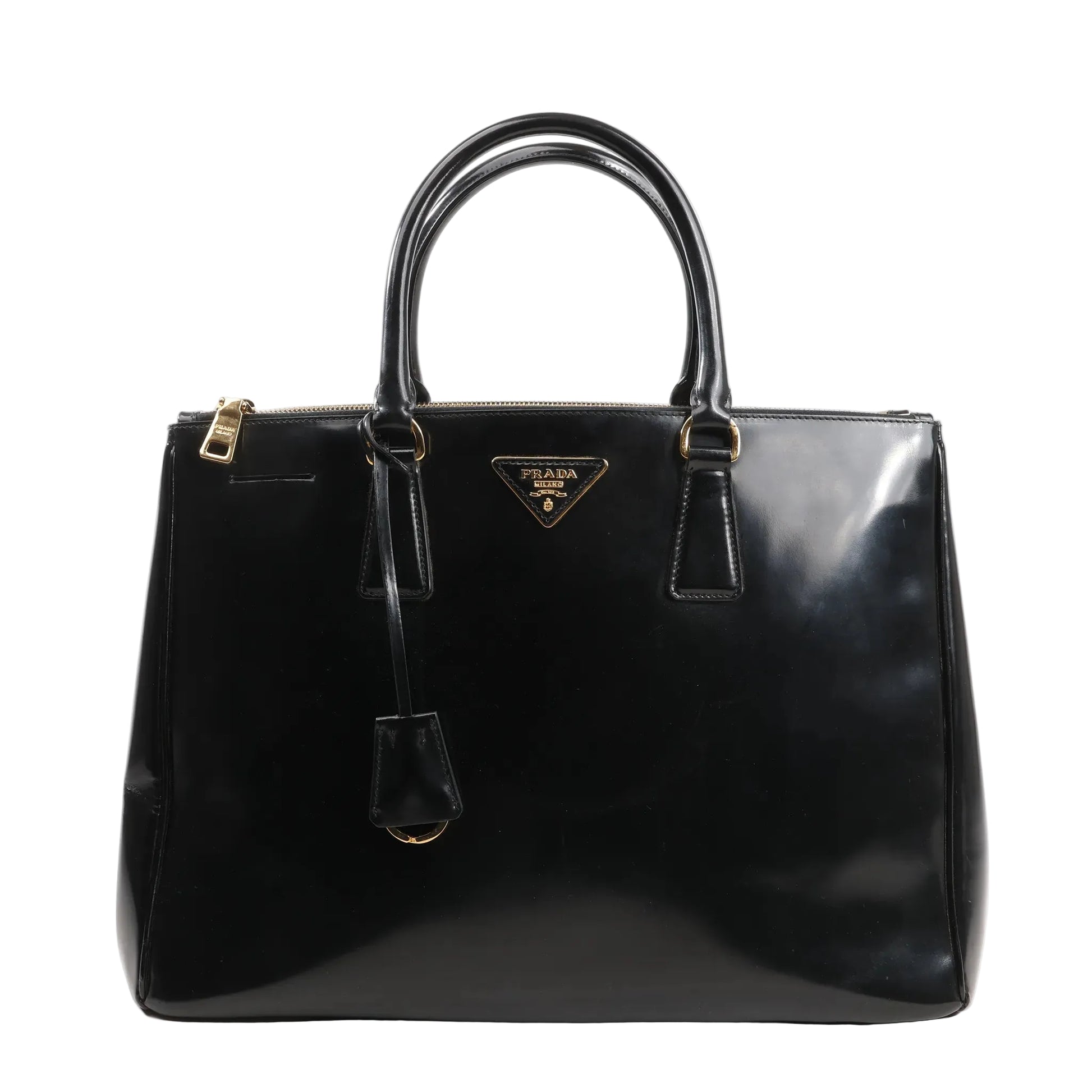 Prada Galleria 2Way handbag in black Saffiano Lux smooth leather, featuring dual rolled top handles, gold-tone hardware, zip closure, signature triangle logo plaque, and a hanging leather clochette.